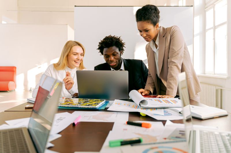 IT professionals collaborating at a laptop