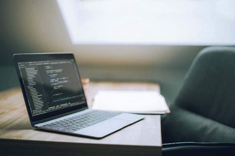 Laptop displaying website development code